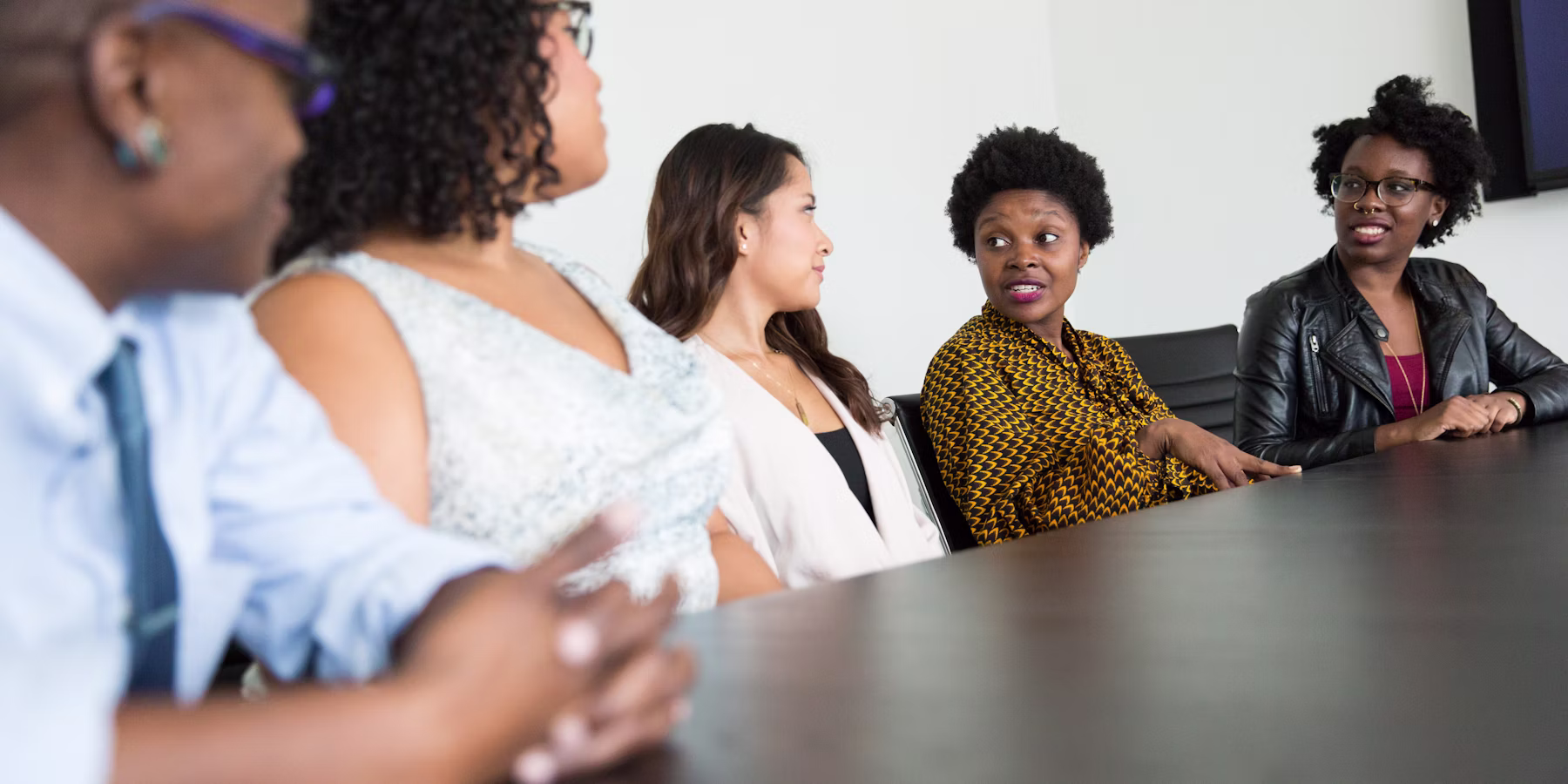 Young Black professionals in a corporate meeting